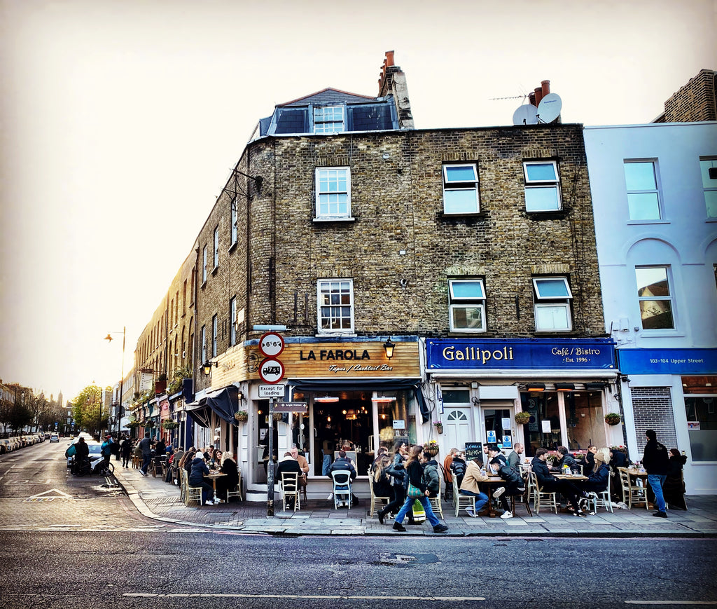 Street with several restaurants with people sitting outside